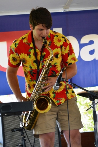 Musician plays saxophone on stage