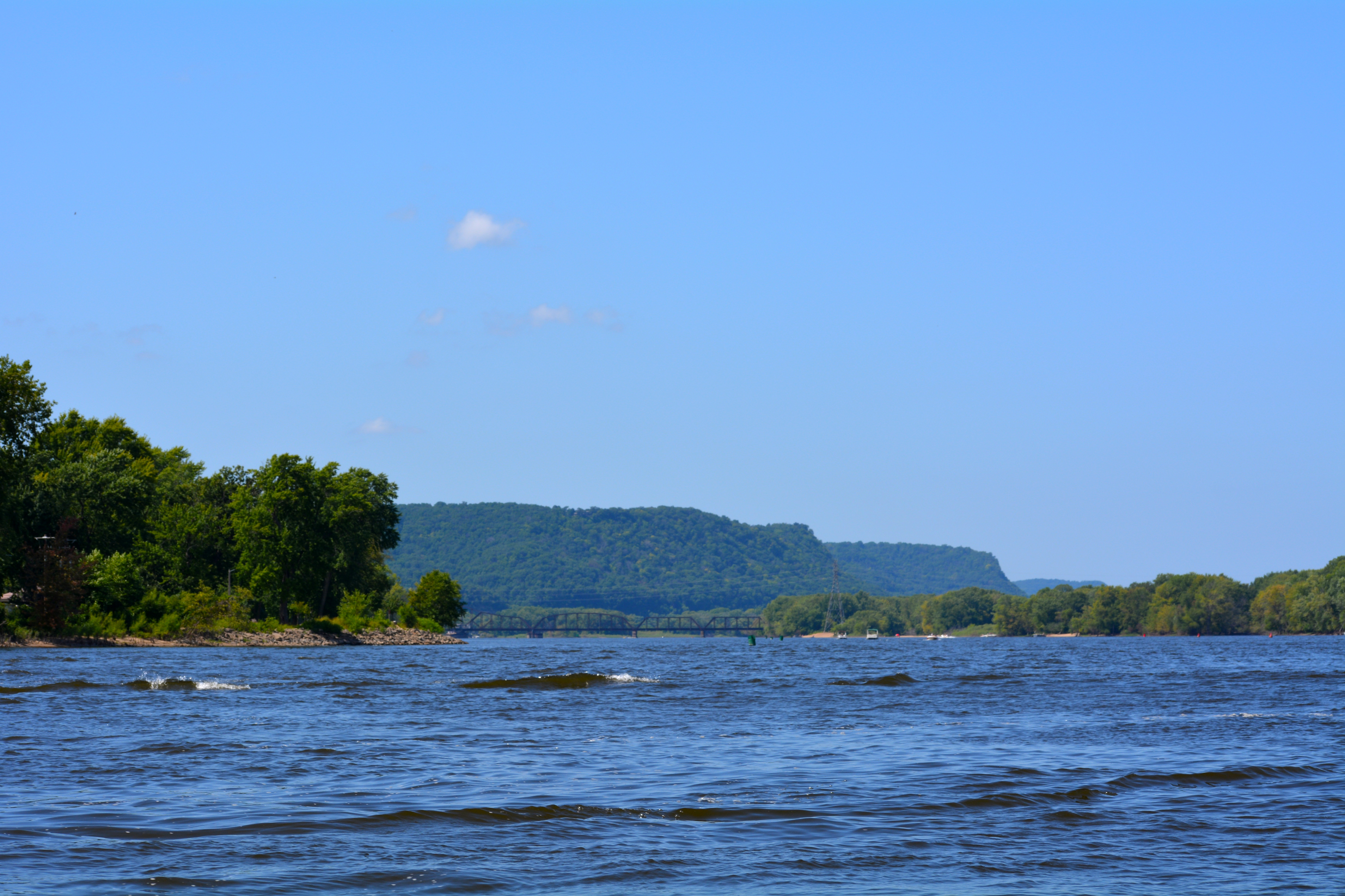 The view of bluffs in the distance shot from the river