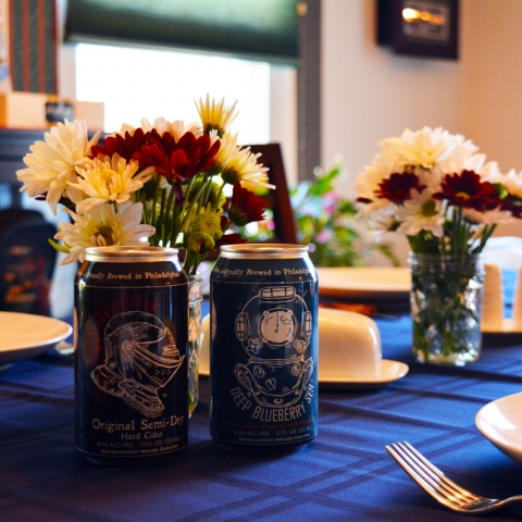 A photo of cans of Sir Charles Hard Cider on the dinner table