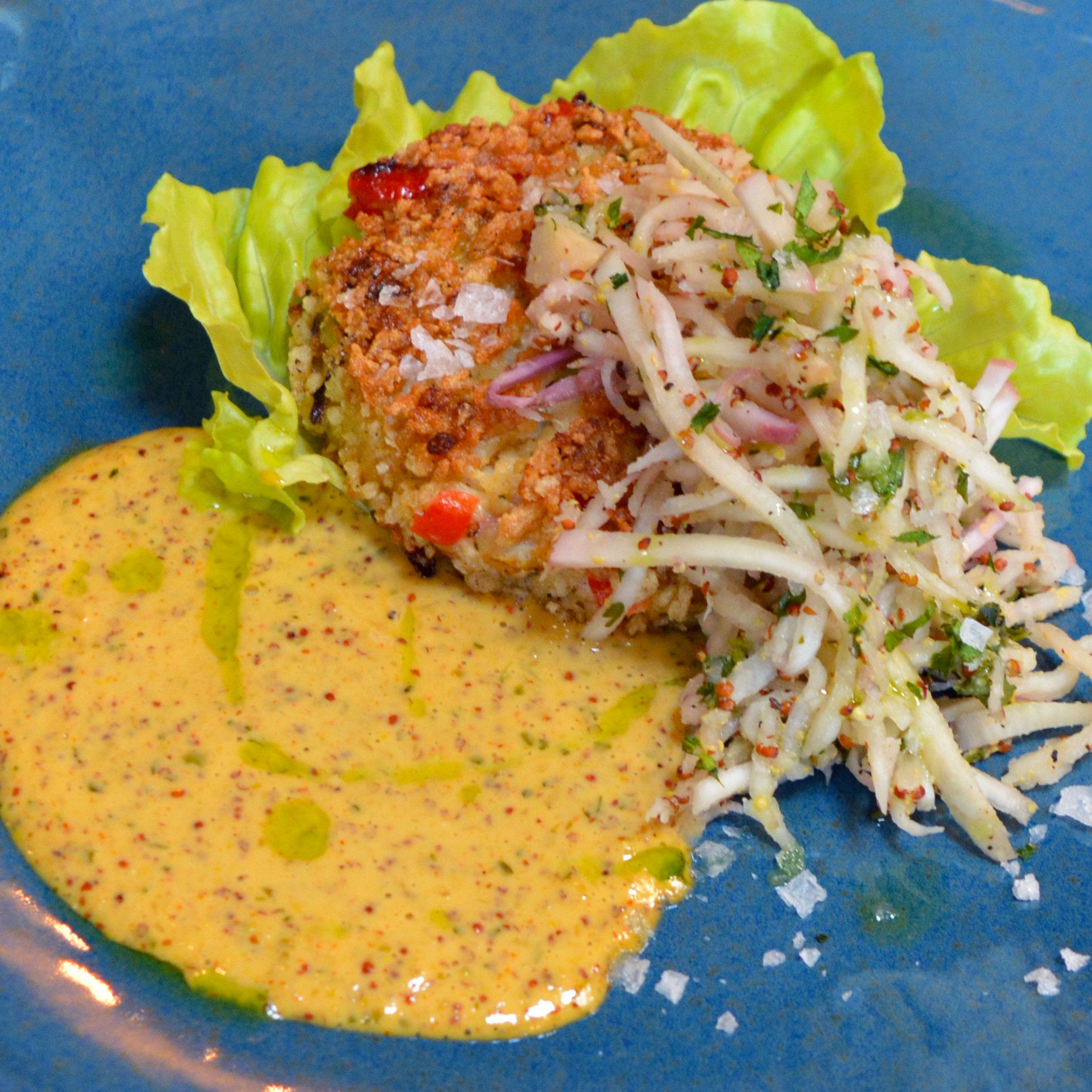 A Crab Cake with lettuce and coleslaw